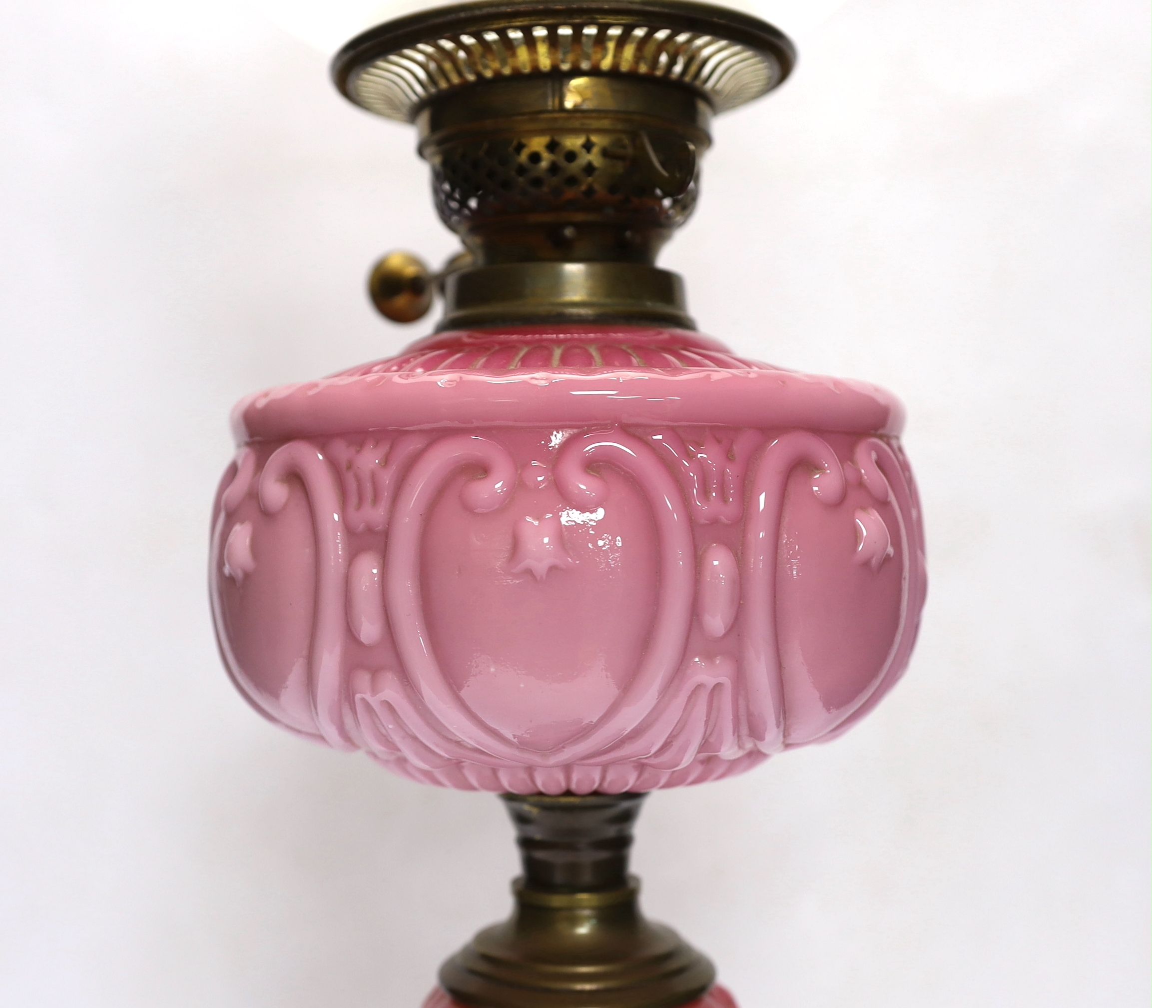 A late 19th century pink and white glass oil lamp, 73cm high